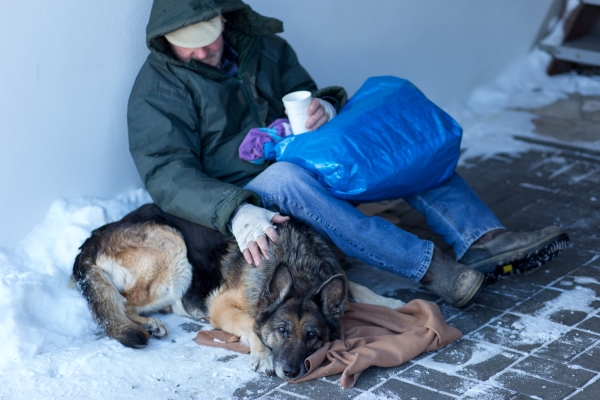 Une personne sans domicile fixe et son chien dans la rue